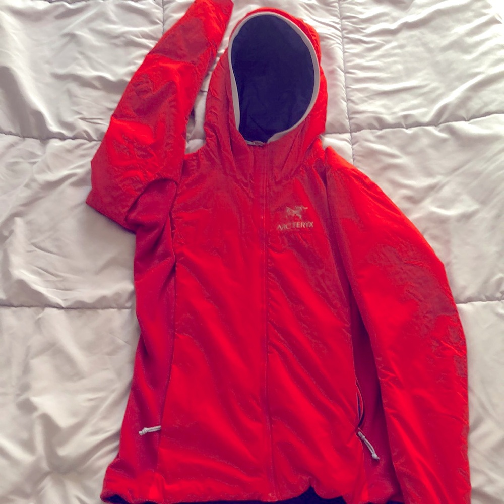 Dark orange lightweight Arc’teryx jacket